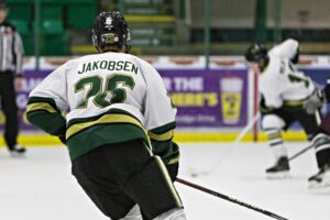 Markus Jakobsen watching Michael Mikan carry the puck. (Scott Savard/Okotoks Oilers)