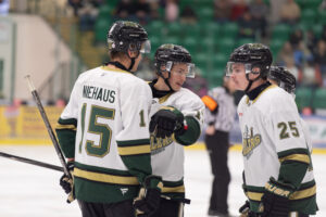 Jeff Niehaus (left), Ben Deacon (Centre), and Trey Fredenberg (right) discussing a play. (Chad Goddard/Okotoks Oilers)